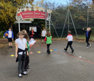 children having a PE lesson on the school playground